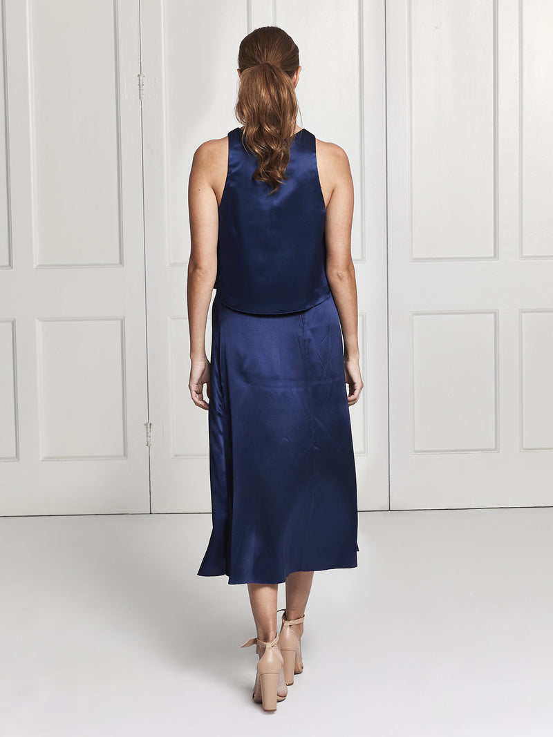 The rear view of the Eve midi silk skirt and top set in blue worn by Heloise Agostinelli